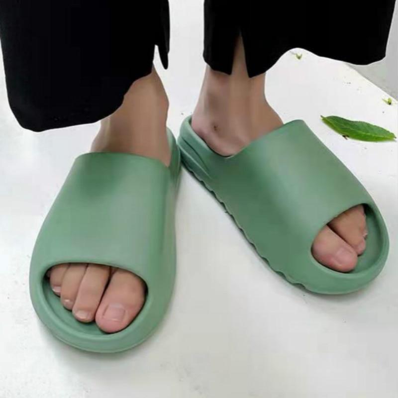 Green comfort recovery slides with lightweight cushioned sole for everyday wear.