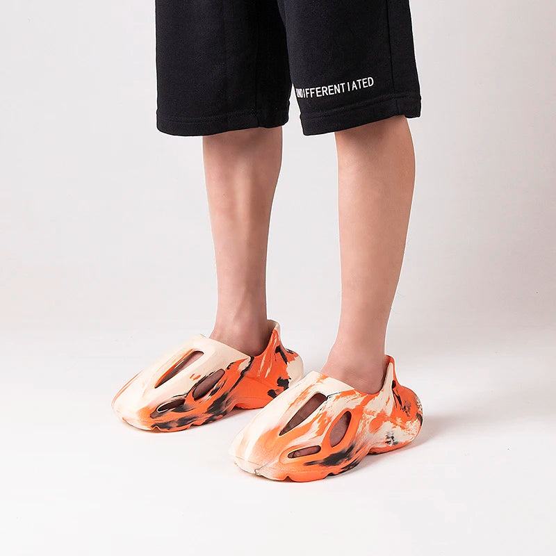 Slip-on platform clogs with adjustable heel strap and breathable upper.