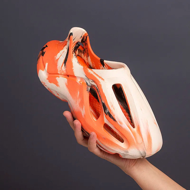 Camouflage platform clogs in orange and white with lightweight EVA comfort.