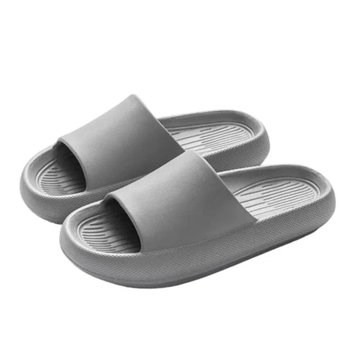 Women's thick sole cloud slippers with modern minimalist style.